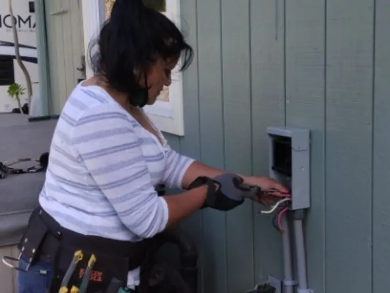 Licensed electrician wiring an exterior subpanel in Wayland