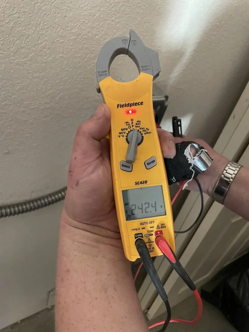 Voltage testing with clamp meter during Recessed Lighting Installation in Wayland